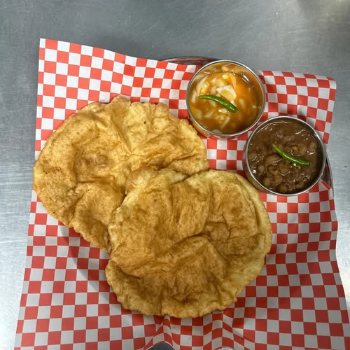Puffed bhatura with chickpea accompaniments at Lutf Indo-Pak Cuisine